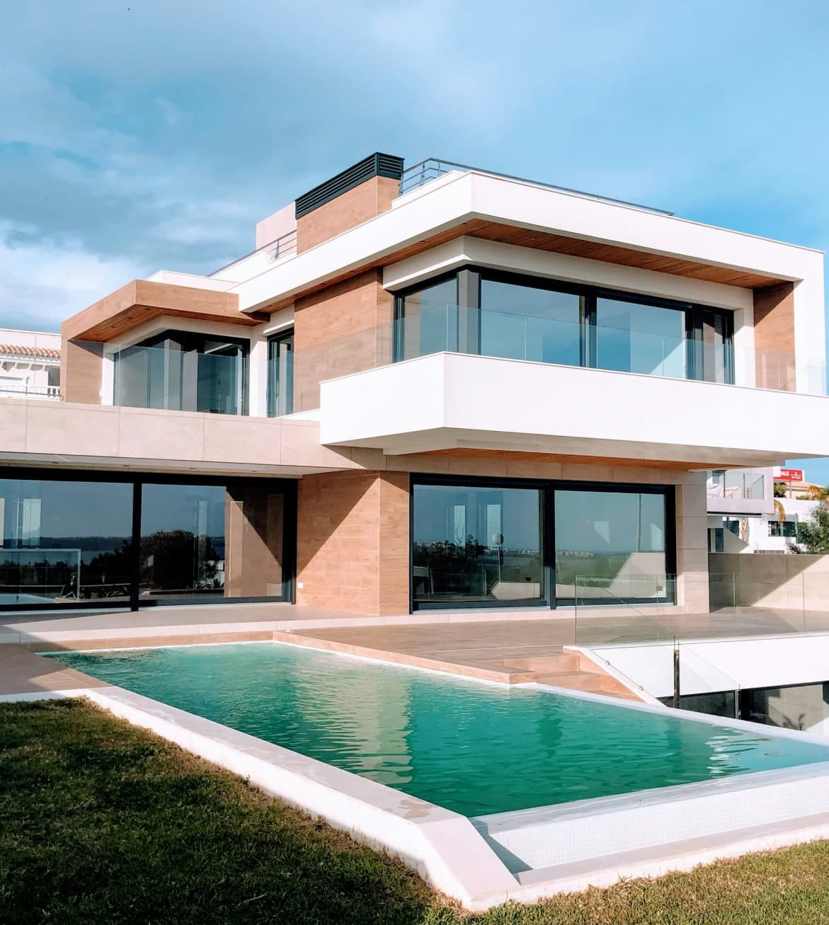 Modern two-storey home with an infinity pool and lawn