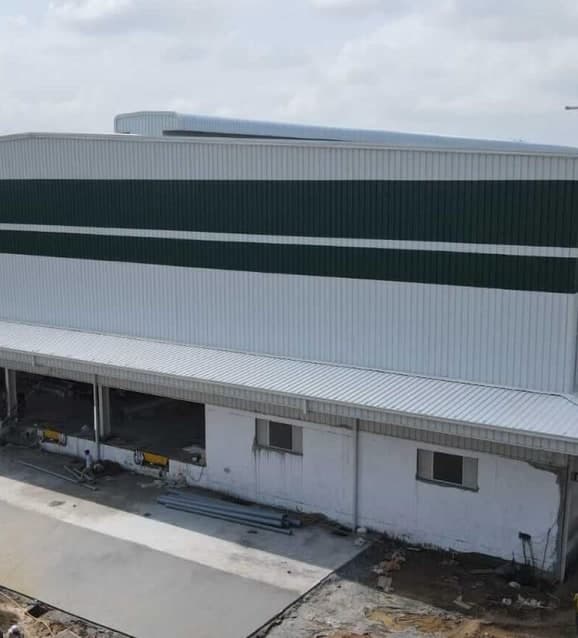 Large industrial shed with metal cladding under construction