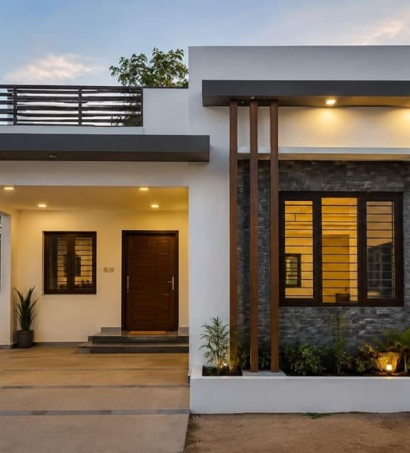Single-storey house with a stone-clad facade and lit entrance